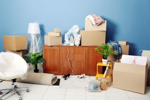 Trained moving staff using safe lifting techniques for household furniture