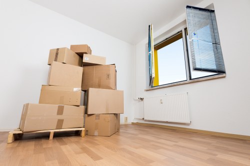 Removalists carrying furniture through a flat in Swiss Cottage