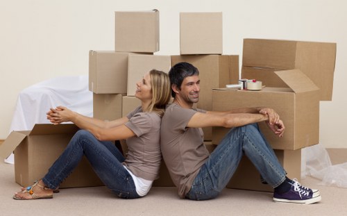 Business relocation team managing labelled boxes and office equipment