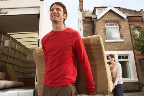 Furniture and household items being loaded into a van in Swiss Cottage
