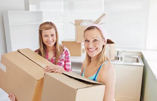 Removals team loading furniture for a Swiss Cottage flat move